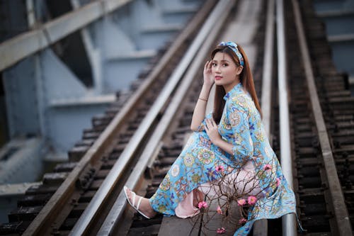 Woman Wearing Traditional Wear Sitting on Railway