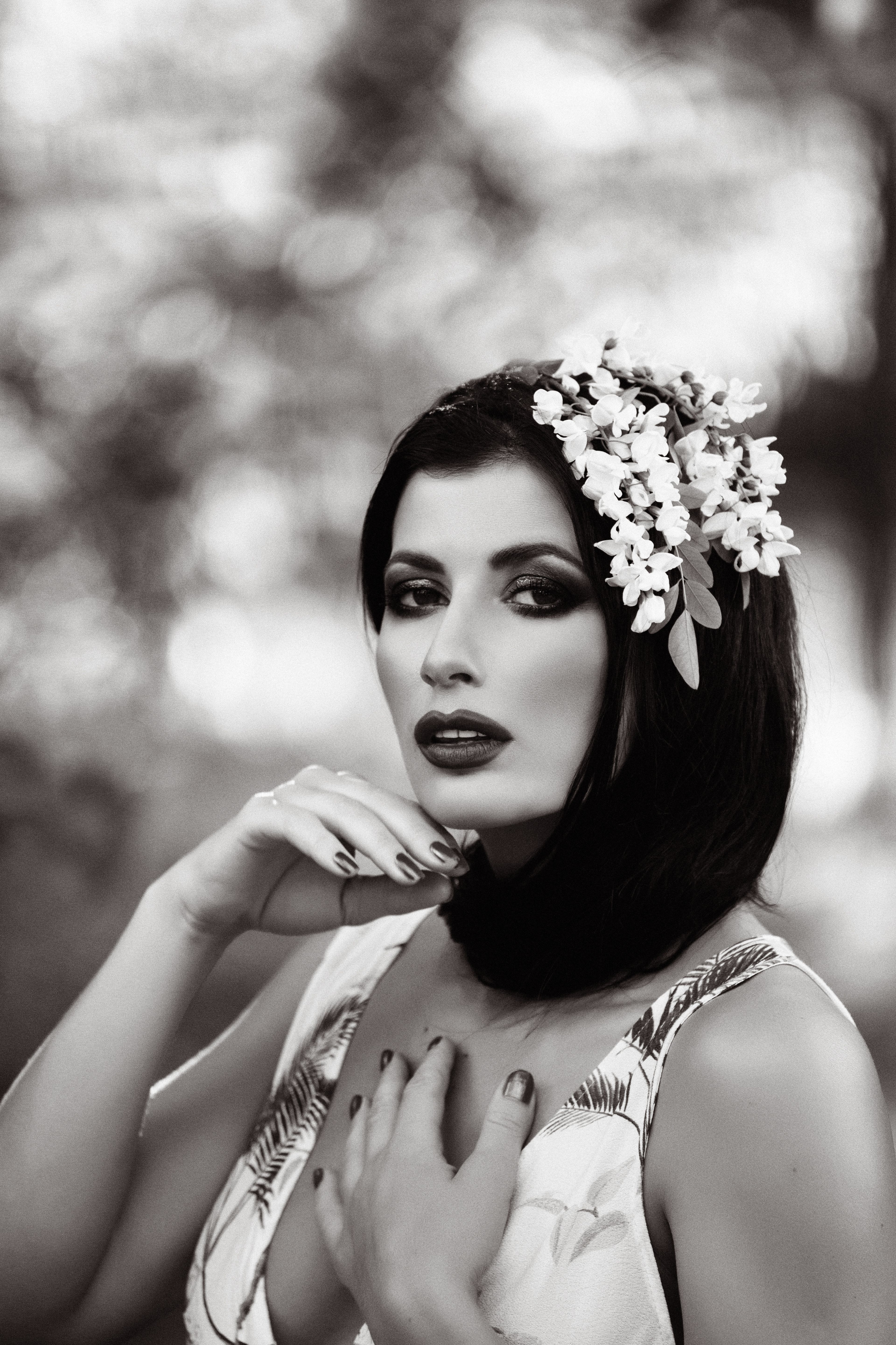 Portrait of a Beautiful Woman Wearing Flowers in Hair · Free Stock Photo