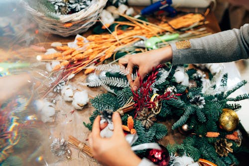Close Up Shot of a Person Decorating a Wreath