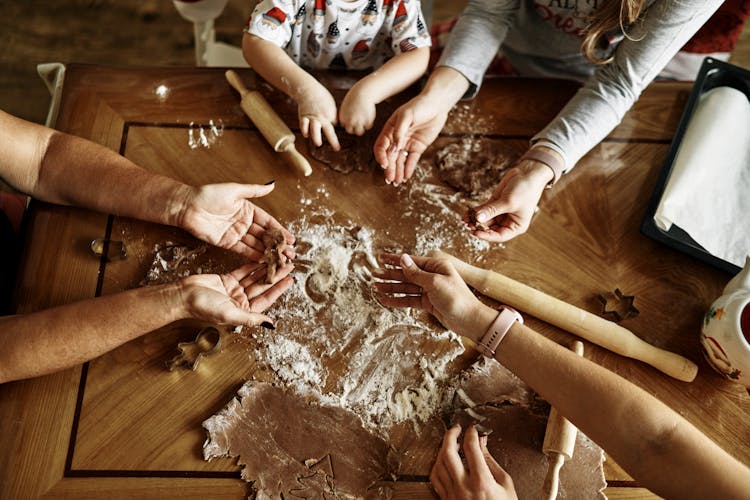 Family Baking Cookies In Kitchen