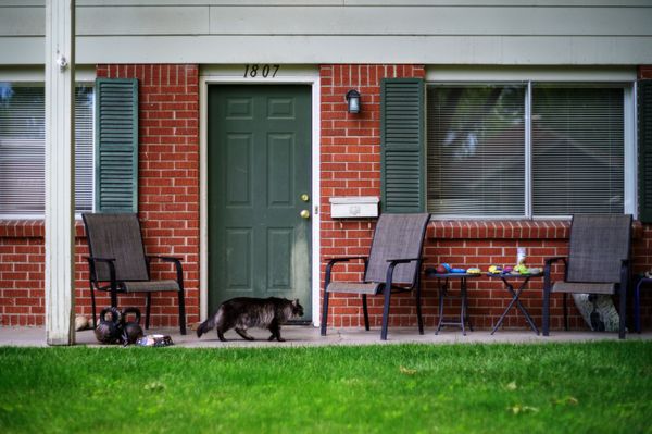 Brick house front porch with outdoor chairs