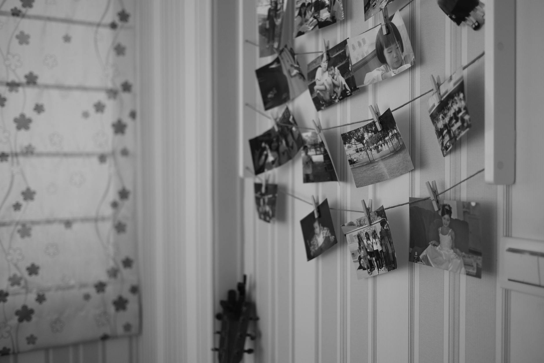 Grayscale Photo of Pictures Hanging on Clothespins