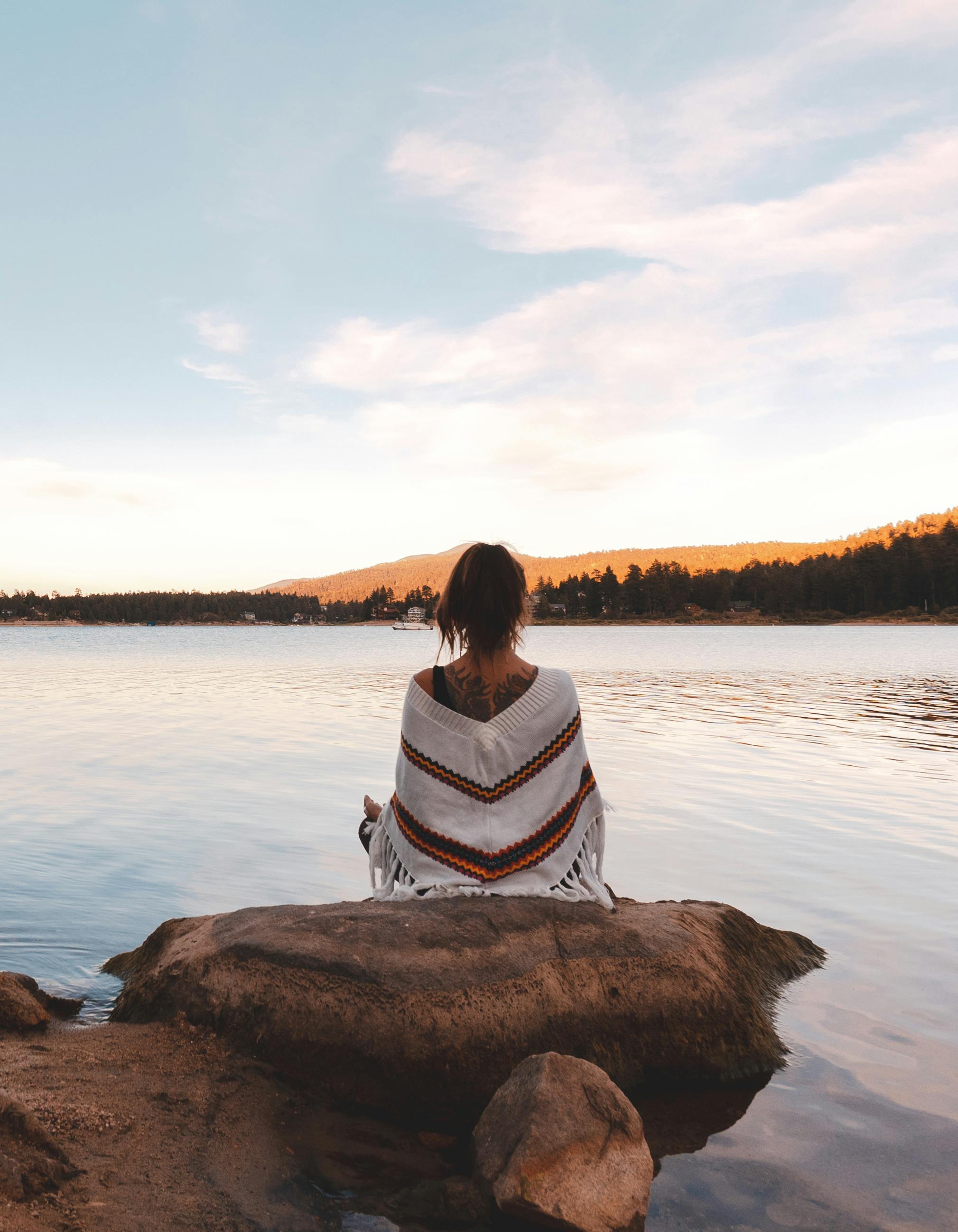 Free Back View of a Woman Meditating by a Lake Benefits of Meditation Photo Mastering Meditation Overcoming Common Challenges for an Aesthetic Life