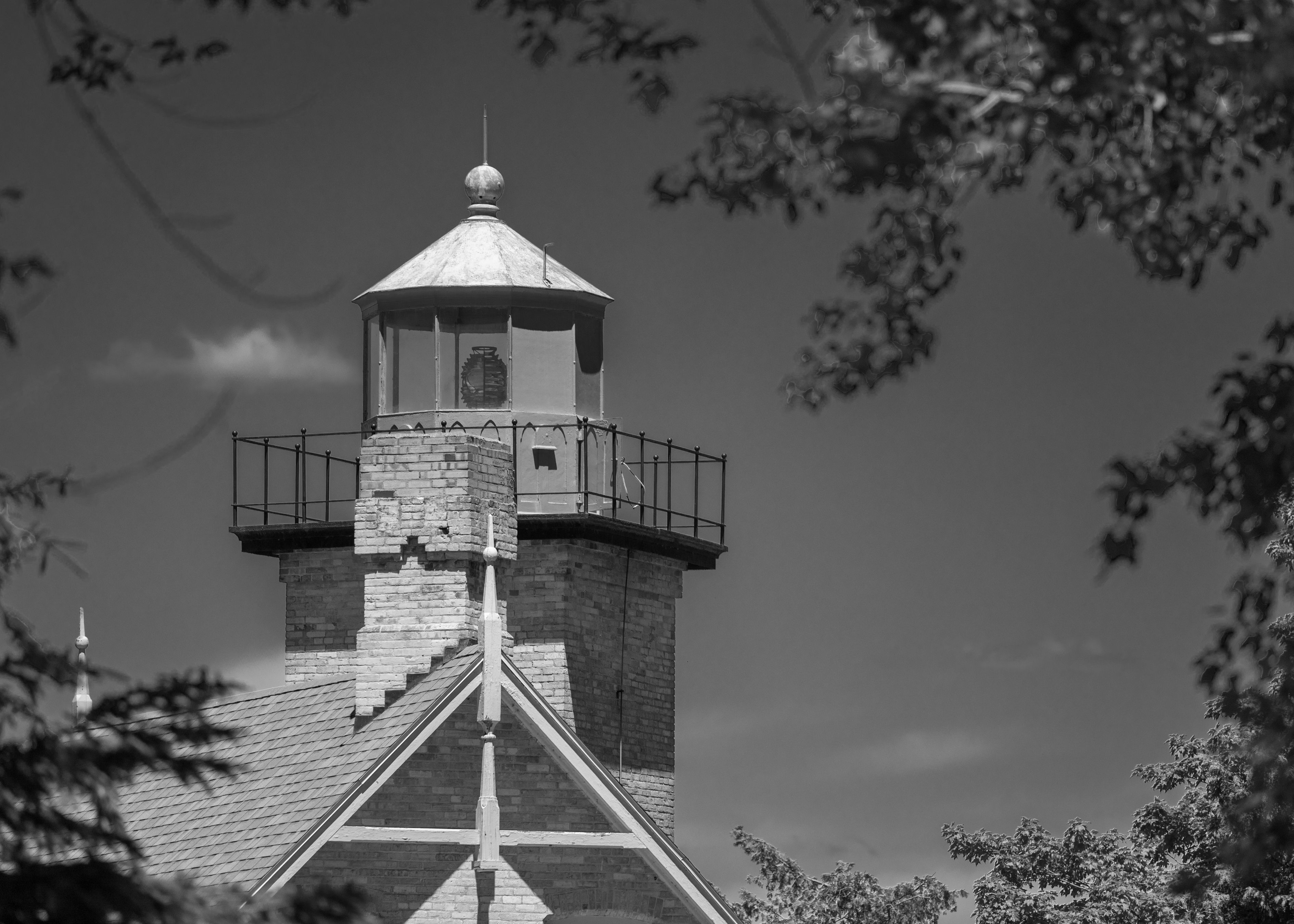 A historic black and white lighthouse amidst foliage at Eagle Bluff, ideal for travel and architecture themes. A historic black and white lighthouse amidst foliage at Eagle Bluff, ideal for travel and architecture themes.