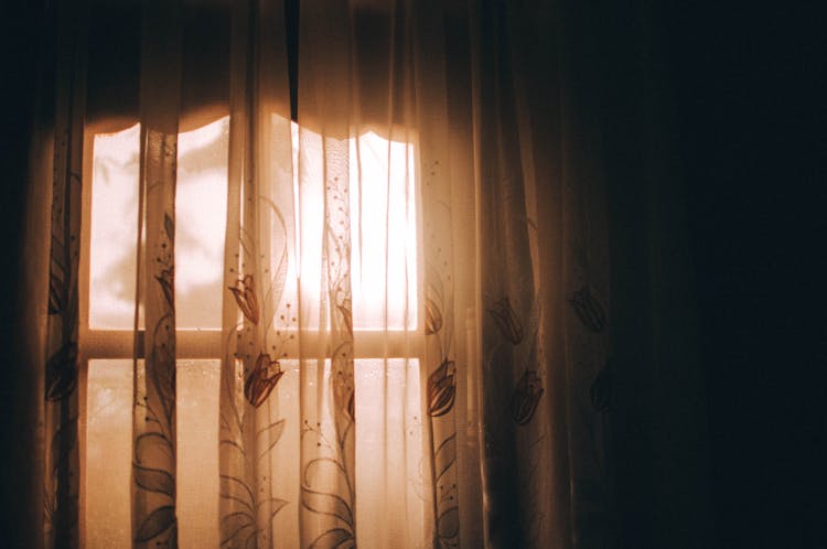 Sunlight Shining Through The Window Curtains