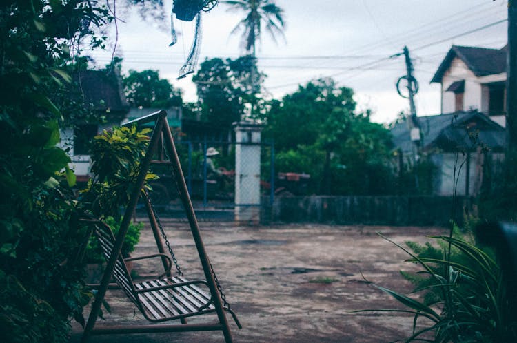 An Old Metal Swing Near Plants