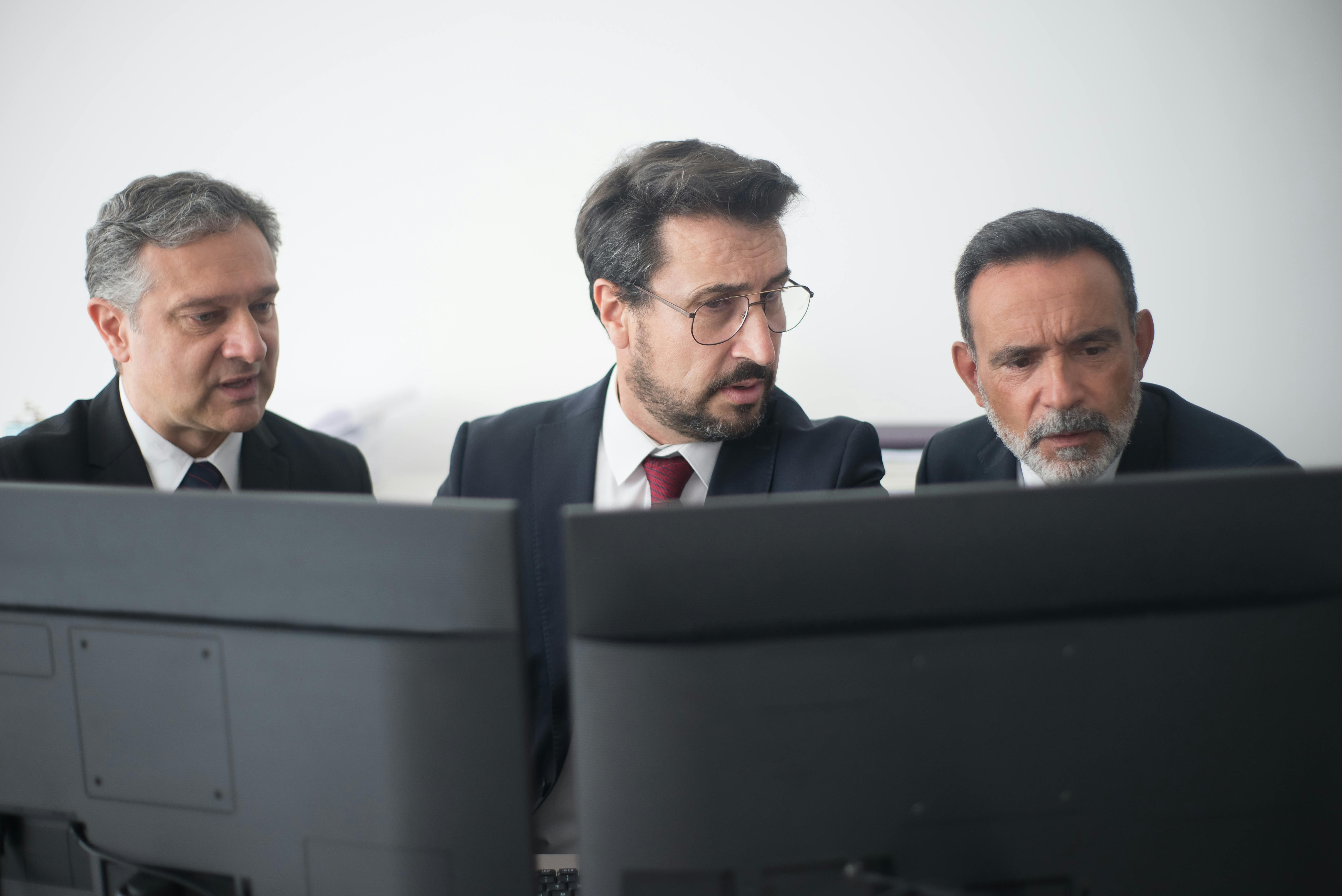 Men in Black Suit Jacket Looking at the Computer Screens · Free Stock Photo