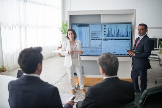 Colleagues discussing financial charts during a corporate meeting in a modern office.