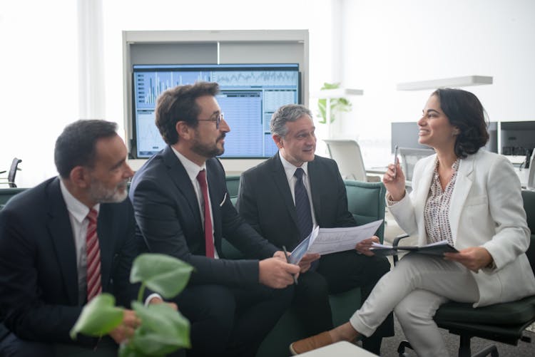 Woman Talking To Men At The Office