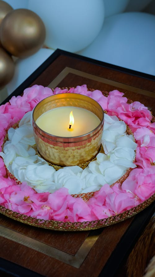 A Candle with a Flower Petal Arrangement