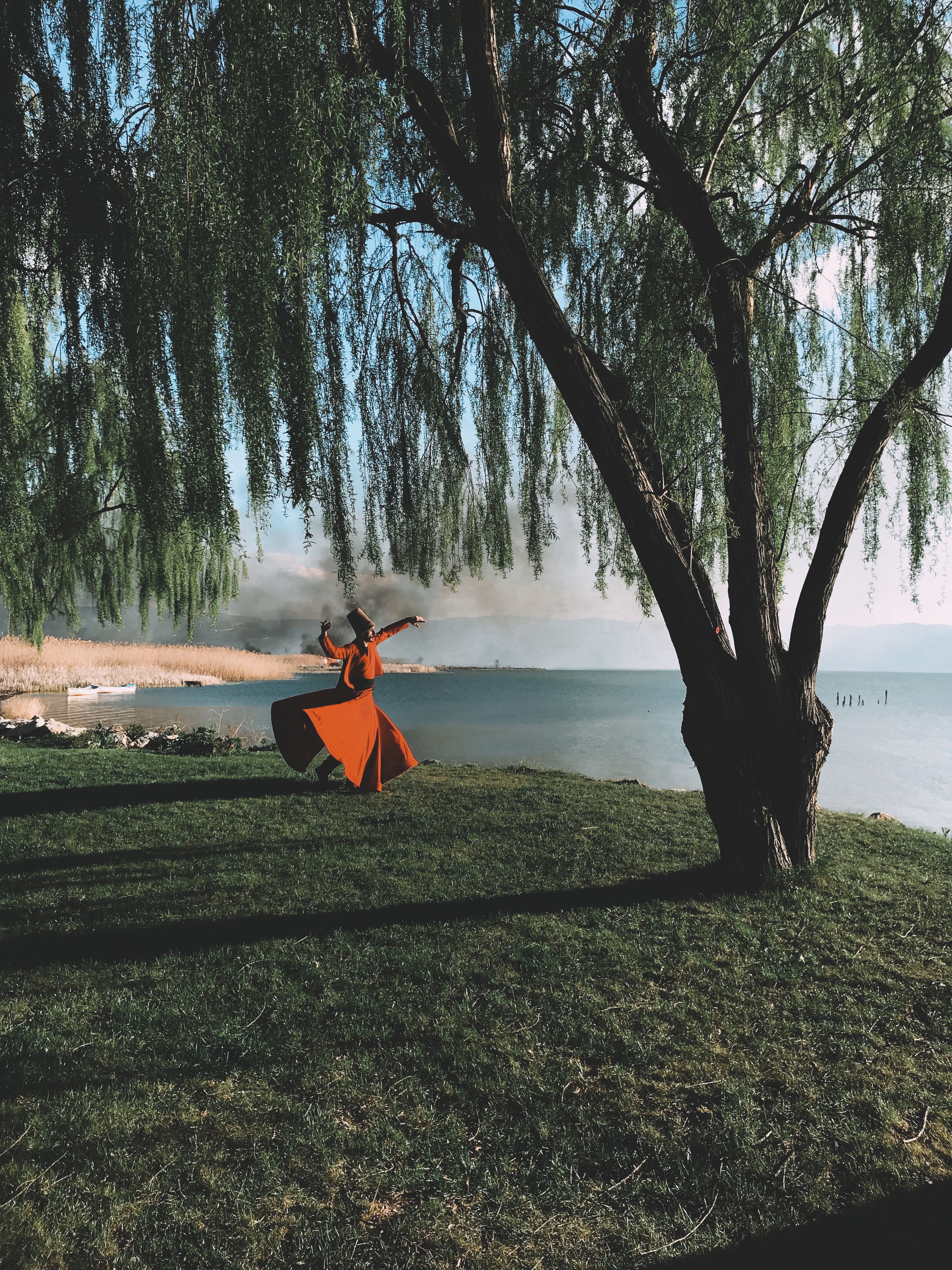 Man in Traditional Dress Dancing by a River · Free Stock Photo