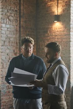 Man in Black Long Sleeve Shirt Holding White Paper