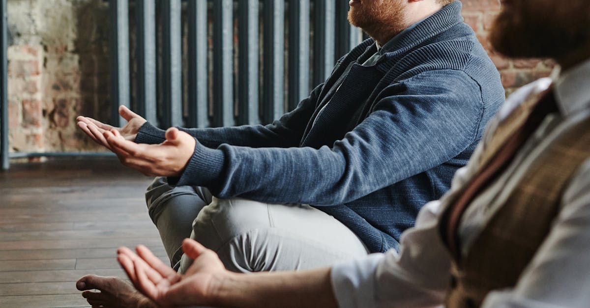 Two men practicing meditation indoors, embodying mindfulness and tranquility.