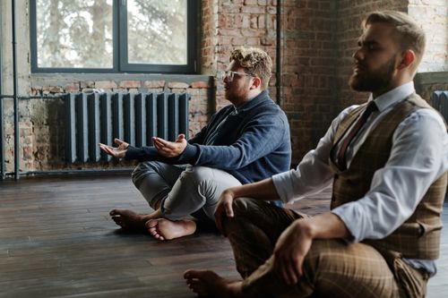 Free Two men meditating quietly in a rustic indoor setting, promoting mindfulness and relaxation. Stock Photo