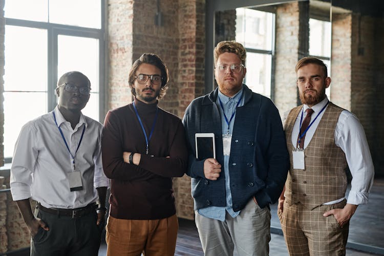 A Group Of Men Standing While Looking With A Serious Face