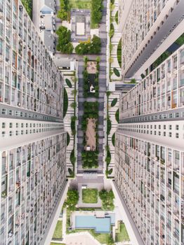 Drone shot capturing the top view of high-rise residential buildings and courtyard greenery.