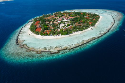 Stunning aerial view of a tropical island surrounded by turquoise waters.