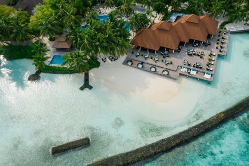 Free Aerial view of a scenic tropical resort with a pristine sandy beach and turquoise waters. Stock Photo
