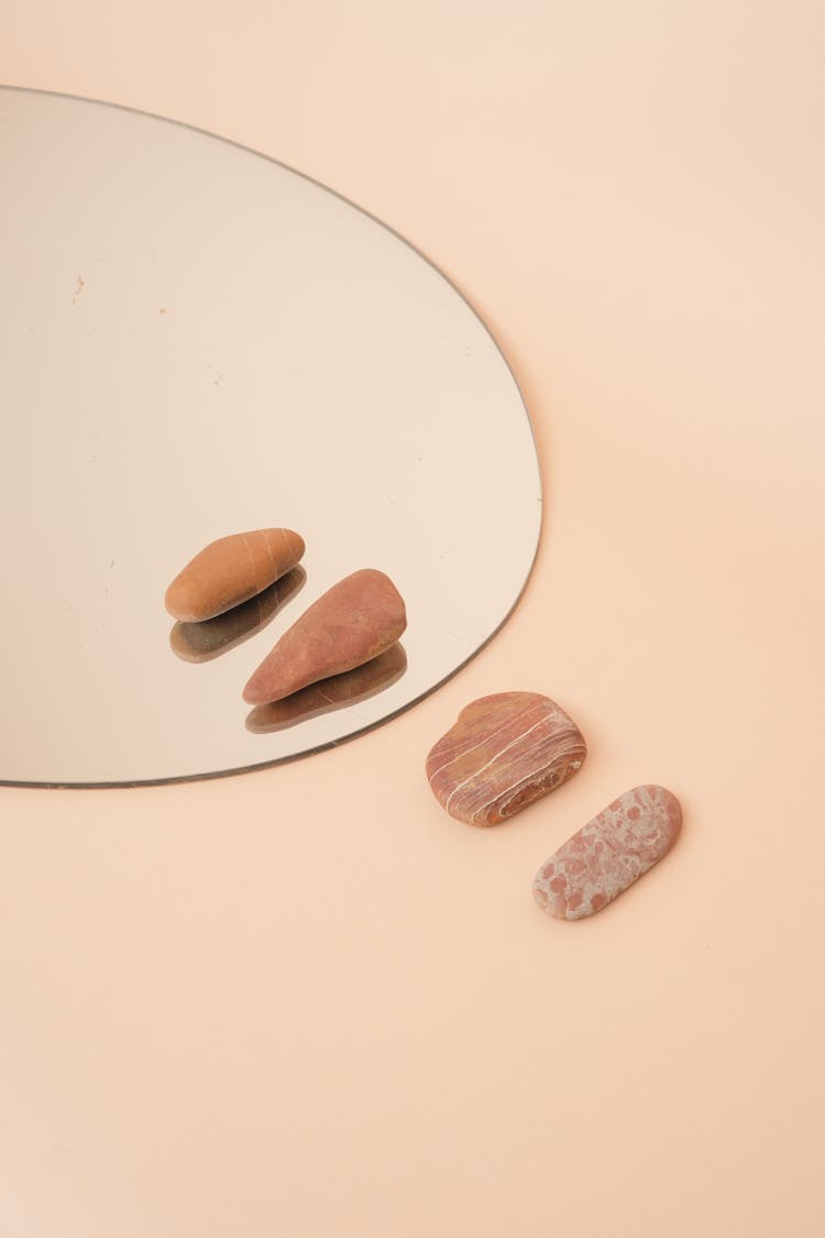 A Stones On Mirror And Beige Surface