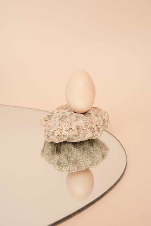 Egg on Beige Stone on the Mirror