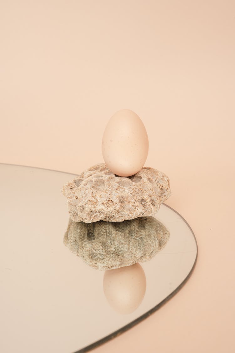 Egg On Beige Stone On The Mirror