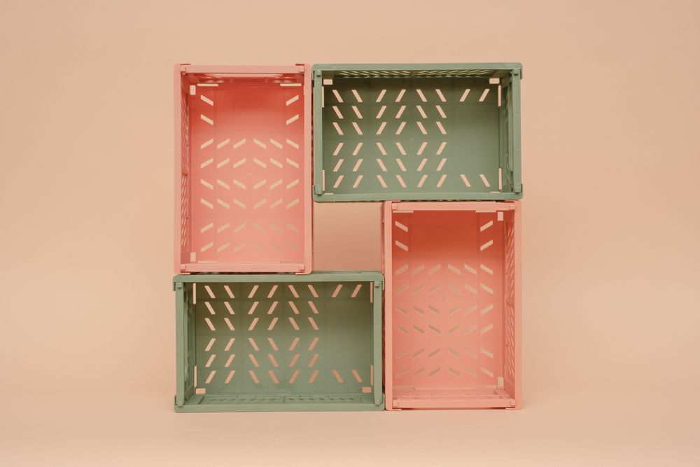 Stacked foldable storage crates in a clean neutral setting