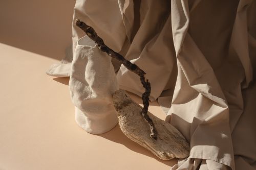 Free A calming still life composition featuring a ceramic vase and natural textures on a beige background. Stock Photo