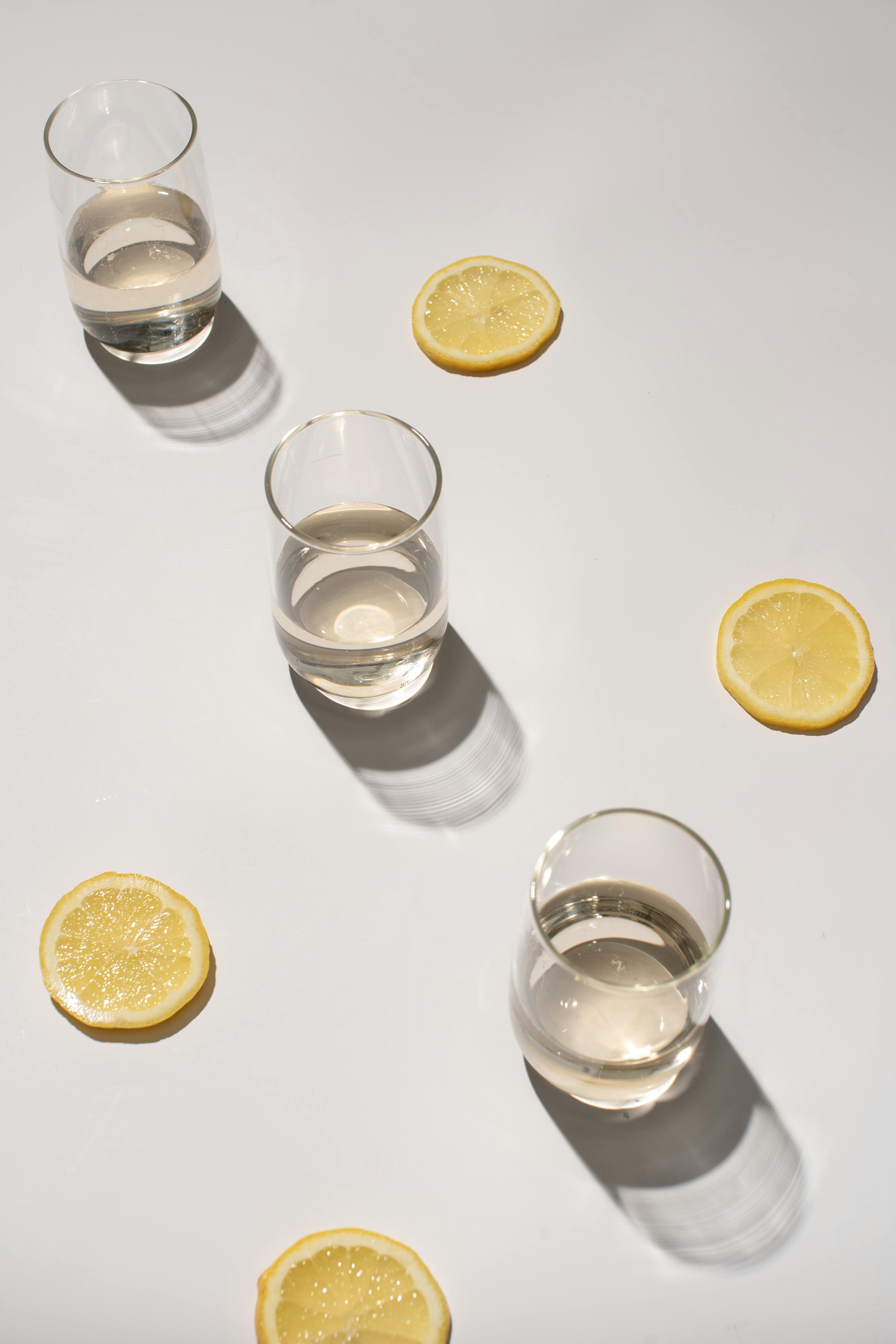 lemon slices near the clear drinking glasses with liquid