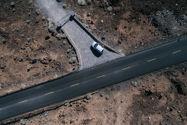 Top View Of A Car On An Unfinished Road  