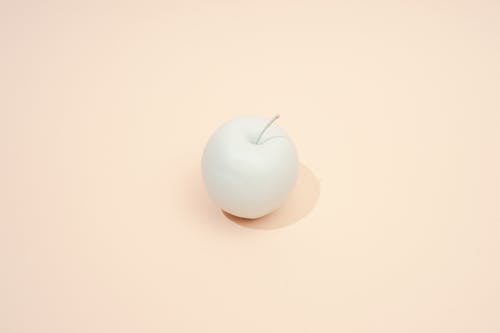 White Apple on Beige Background