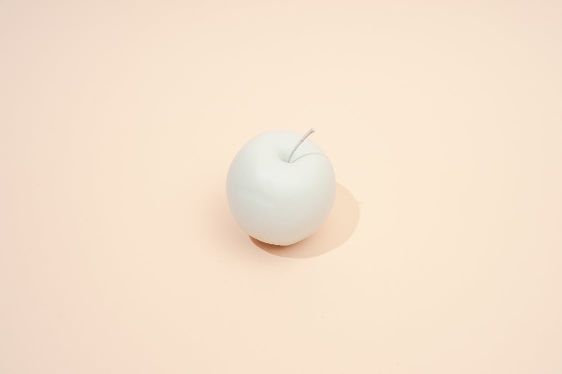Free White Apple on Beige Background Stock Photo
