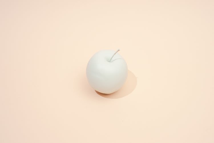 White Apple On Beige Background