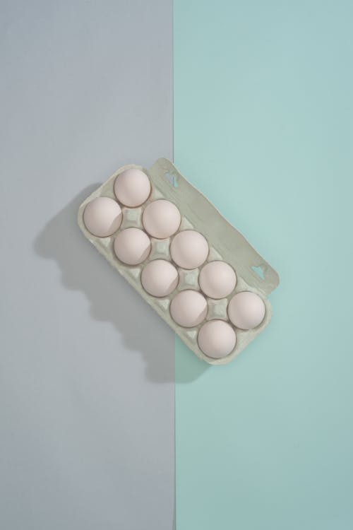 Ten Eggs in Egg Box on Mint and Gray Background