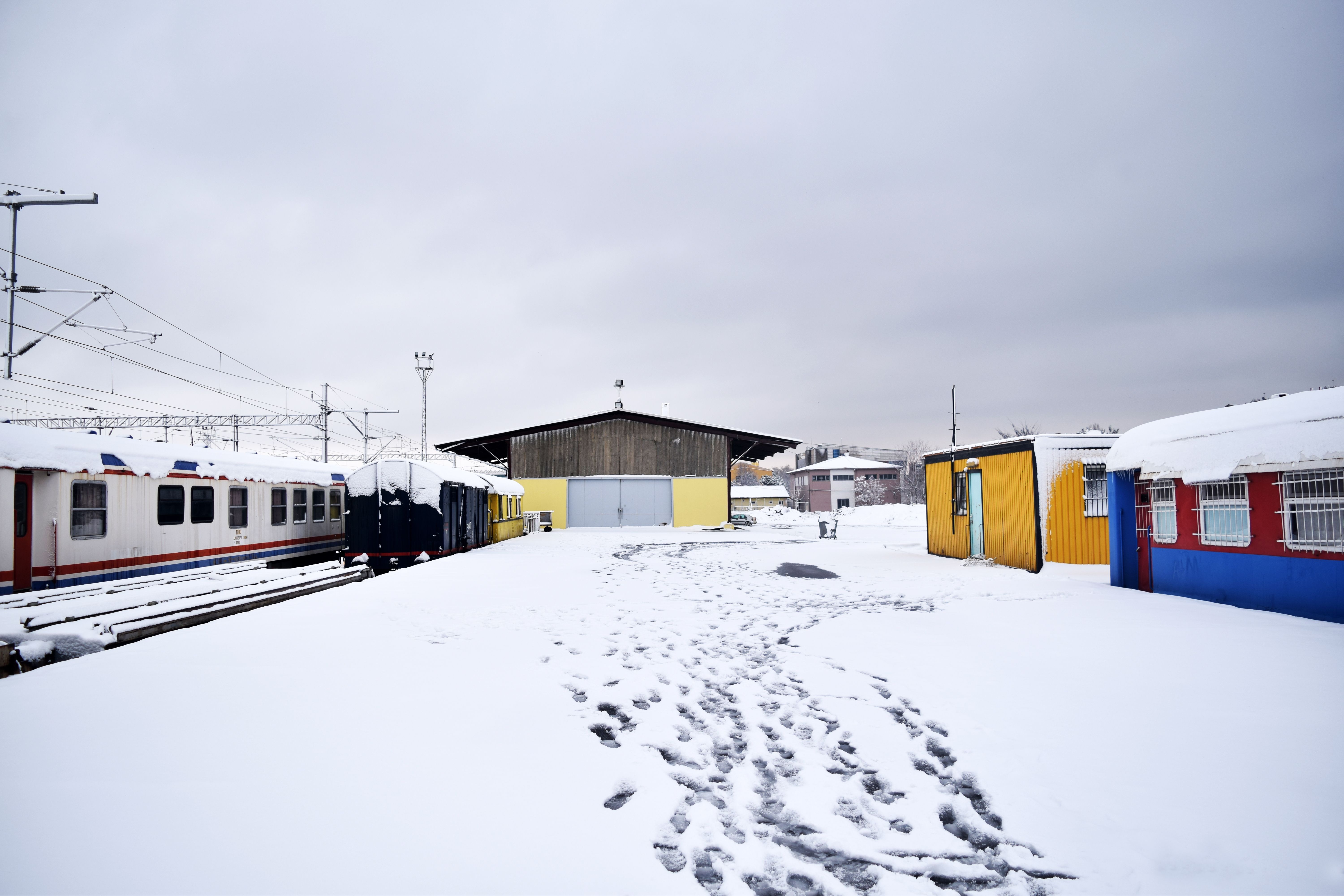 Footsteps on the Snow Beside the Train · Free Stock Photo