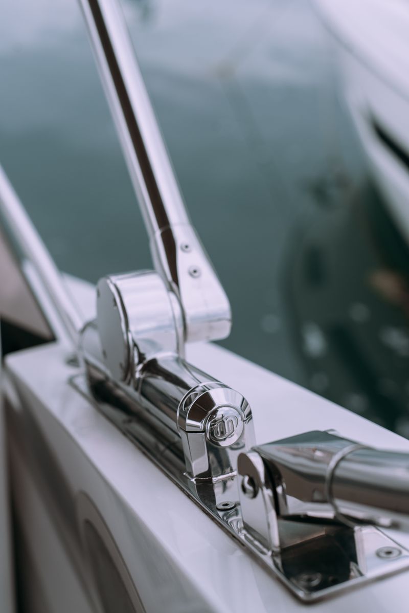 Close-up of shiny stainless steel boat rail with reflective surface on a luxury yacht