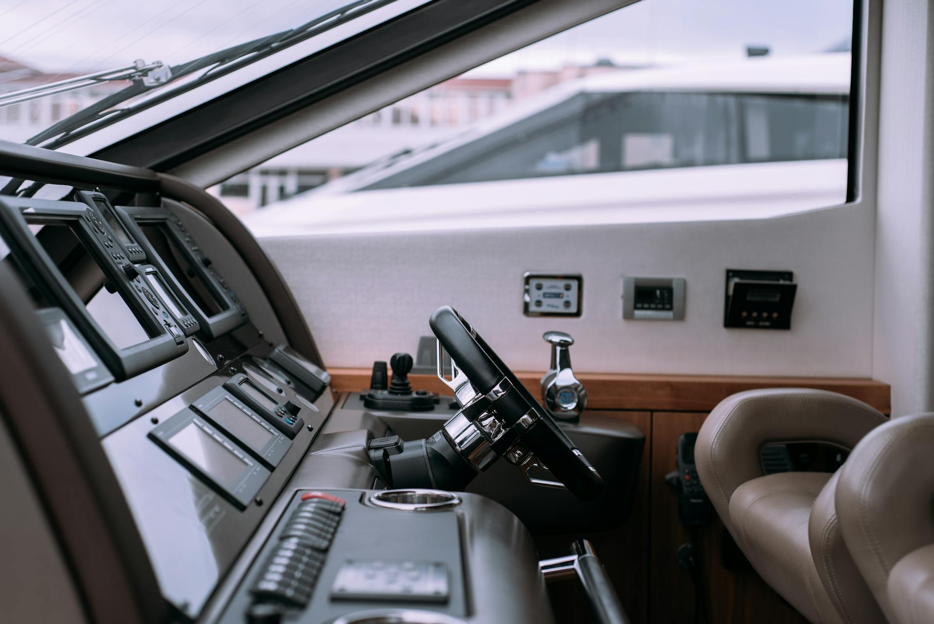 Interior of a luxury yacht showing steering wheel and advanced controls.