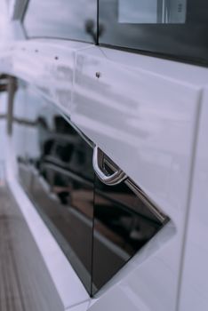 Elegant close-up view of a yacht's exterior handle with sleek design details.