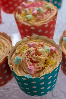 Close-up of colorful cupcakes decorated with sprinkles and marshmallows, perfect for celebrations.