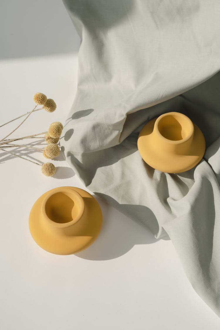Yellow Clay Pot On White Textile