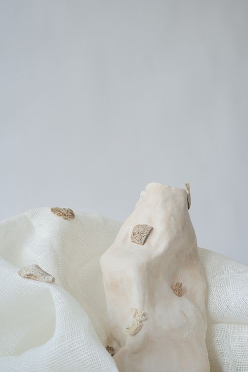Free Minimalistic abstract art featuring a stone and fabric with soft textures and earthy tones. Stock Photo