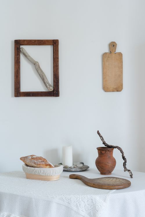 Free Minimalist composition with bread and rustic decor elements on a white table. Stock Photo