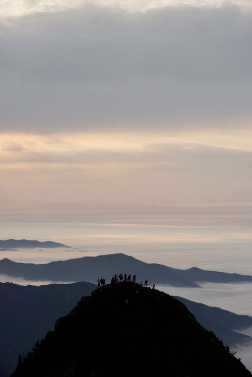 Free Silhouette of People on Top of Mountain Stock Photo