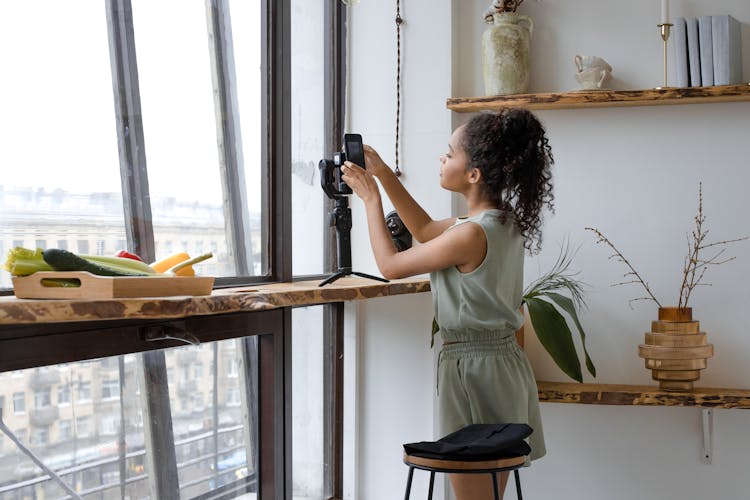 A Woman Setting Up The Camera