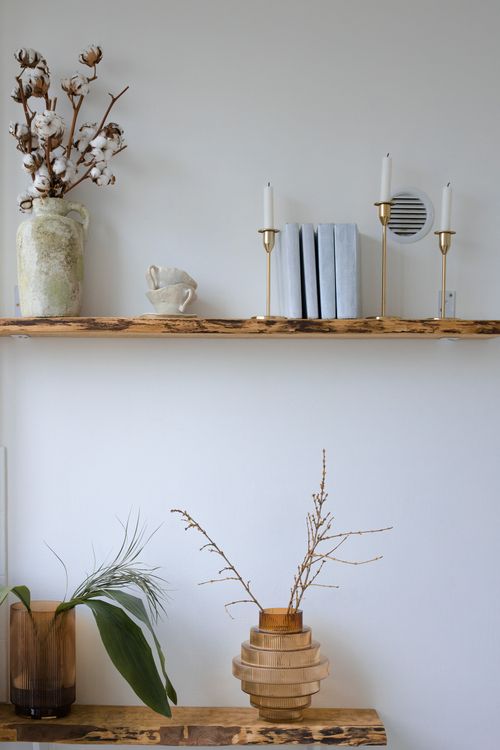 Free Explore minimalist decor with wooden shelves, candles, and botanical elements. Stock Photo