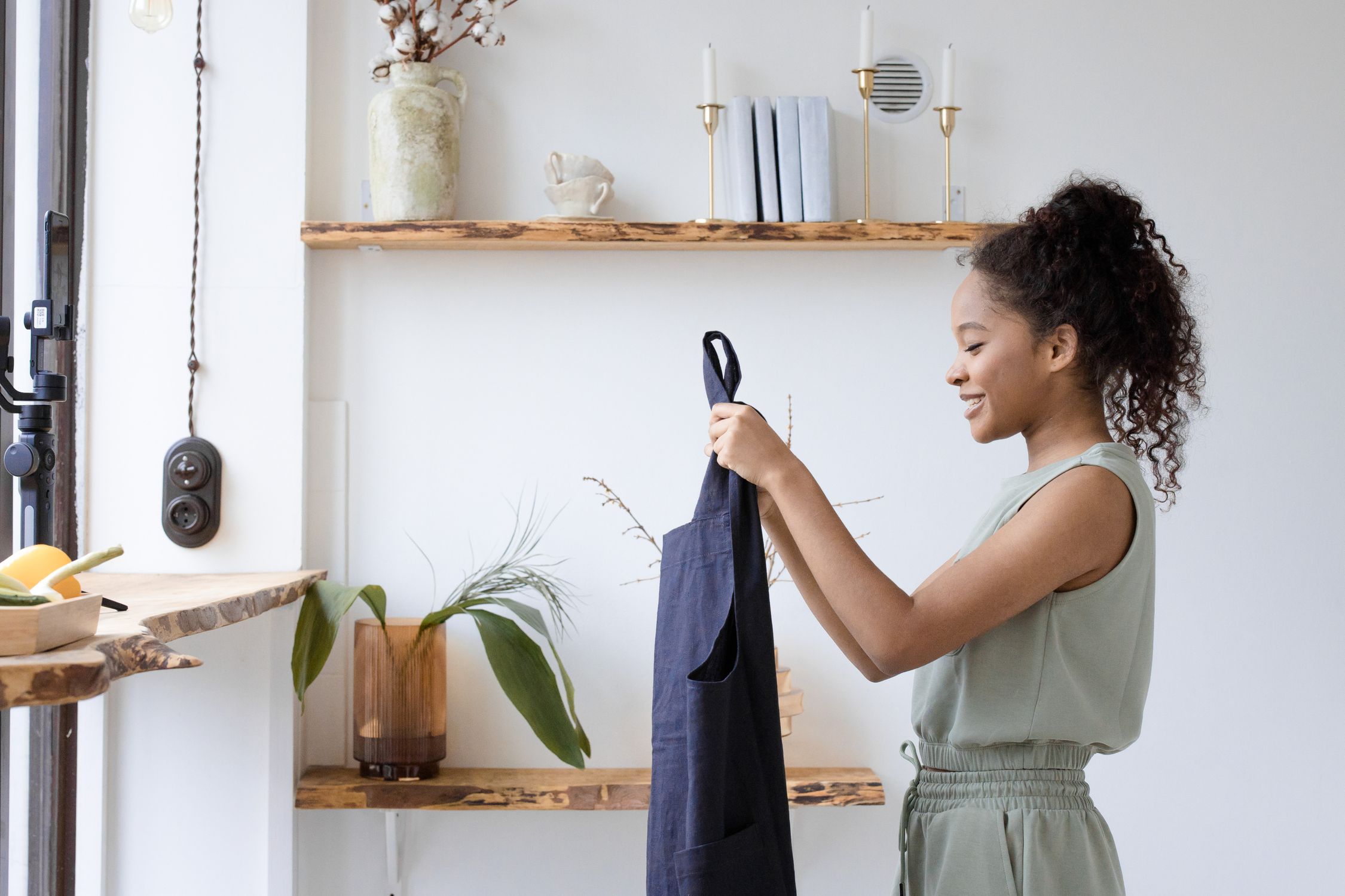 A Woman Holding an Apron · Free Stock Photo