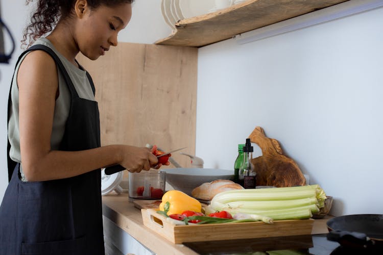 A Woman Slicing The Tomatoes 