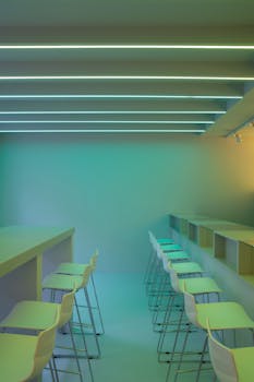 A sleek minimalist bar with neon lighting and modern seating arrangement.