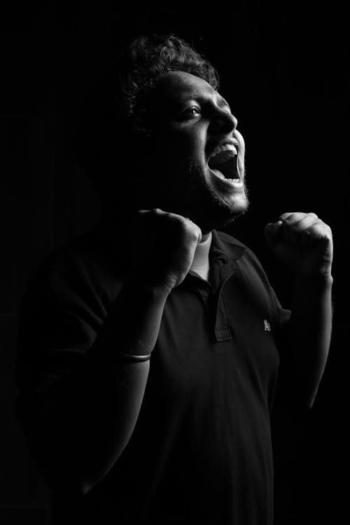 Grayscale Photo of a Man Shouting
