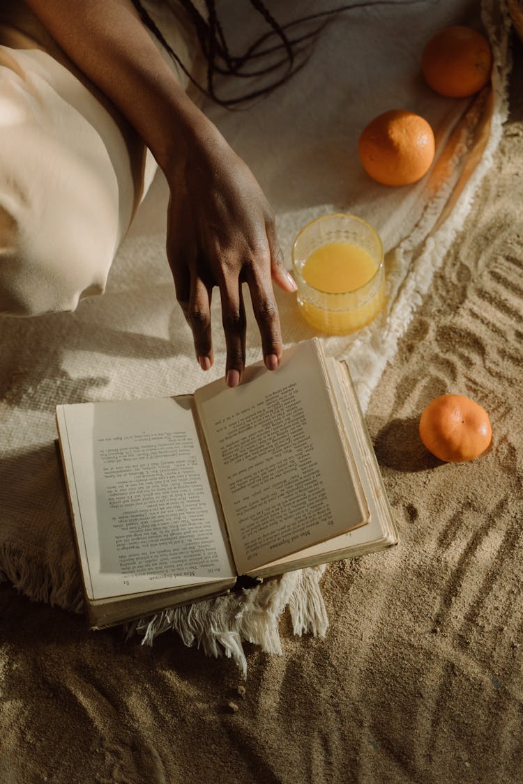 A Hand Flipping The Book Page 