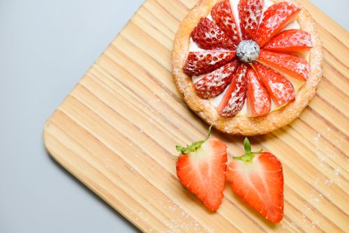 Free Delicious strawberry tart with fresh berries on a wooden board, perfect dessert. Stock Photo